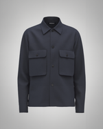 Navy blue cotton twill utility overshirt with a relaxed fit. Features a four-button front closure, two oversized flap pockets, refined topstitching, and a soft matte finish. Fully lined for added structure and durability. Designed for effortless layering and cut and sewn in Australia.